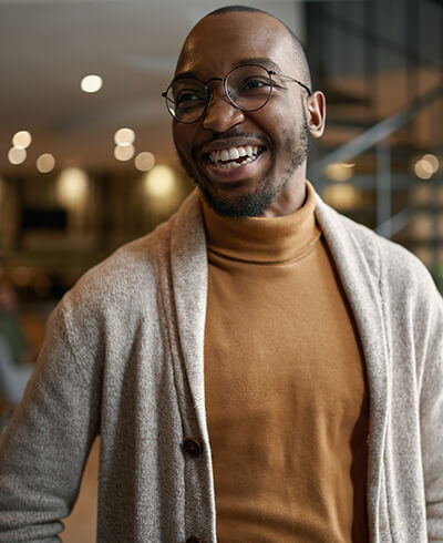 Confident professional man smiling in modern office workspace